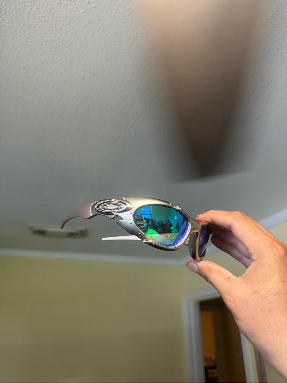 Oakley Metallic Silver Frame Sunglasses with Blue-Green Mirrored Lenses